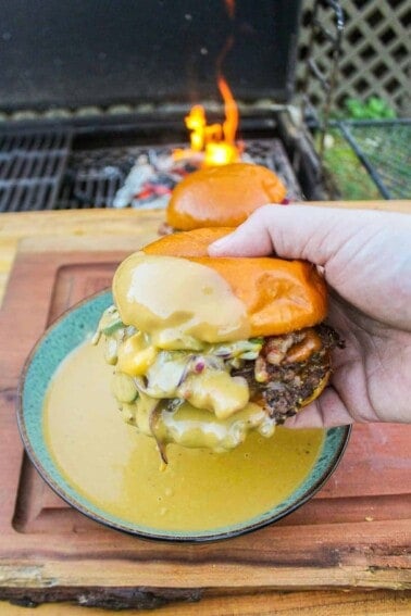 A Beer Cheese Smash Burger after being dipped in the cheese.