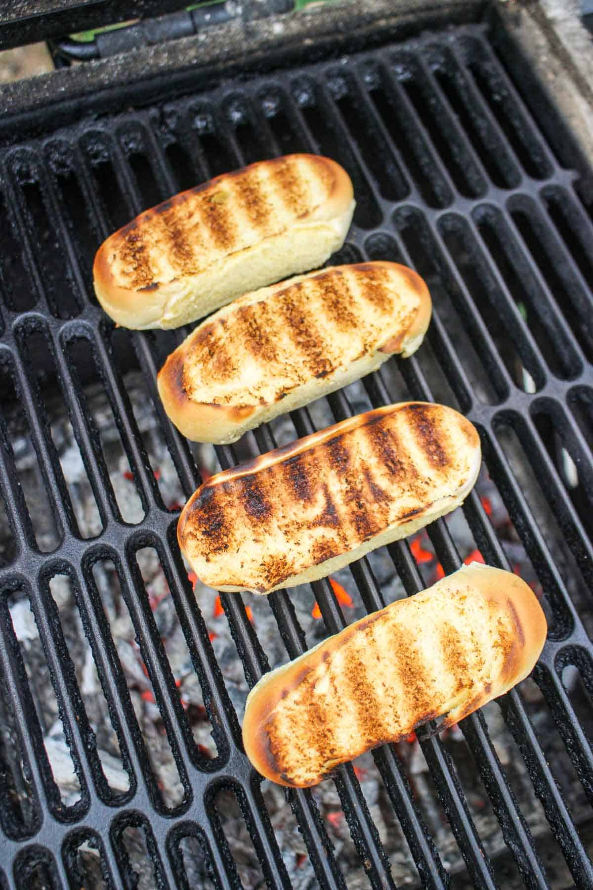 Grilling the sides of the hotdog buns for the grilled shrimp roll. 