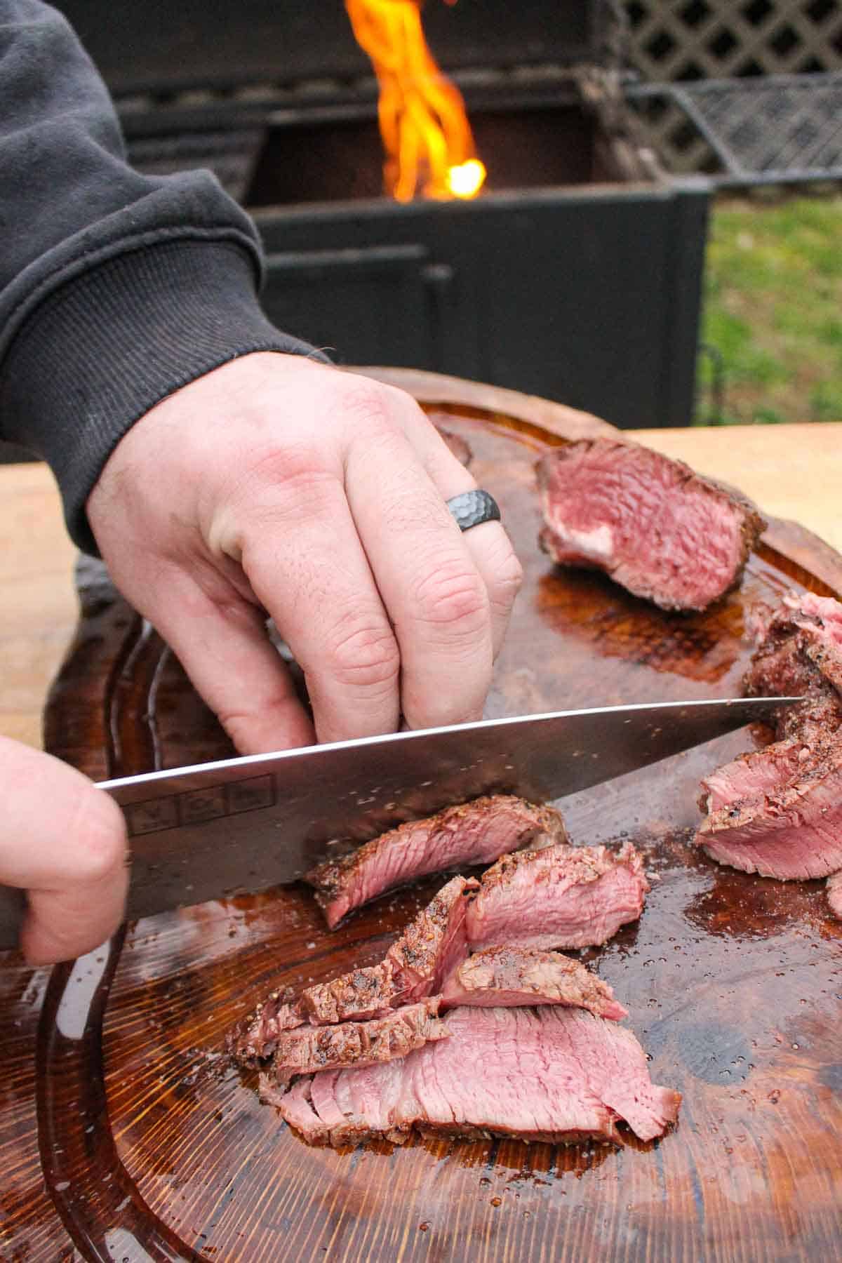 Slicing up the cooked filet mignons.