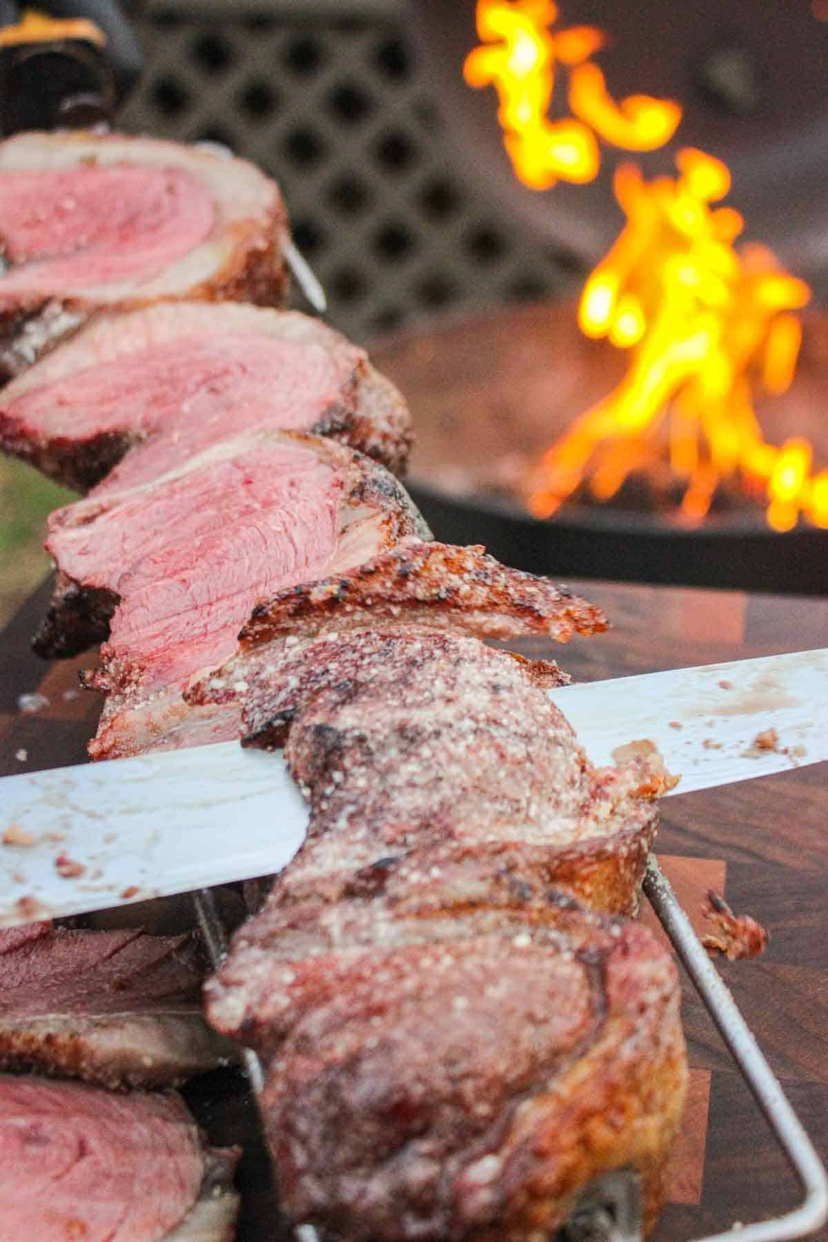 A close up shot of Derek slicing into the steaks.