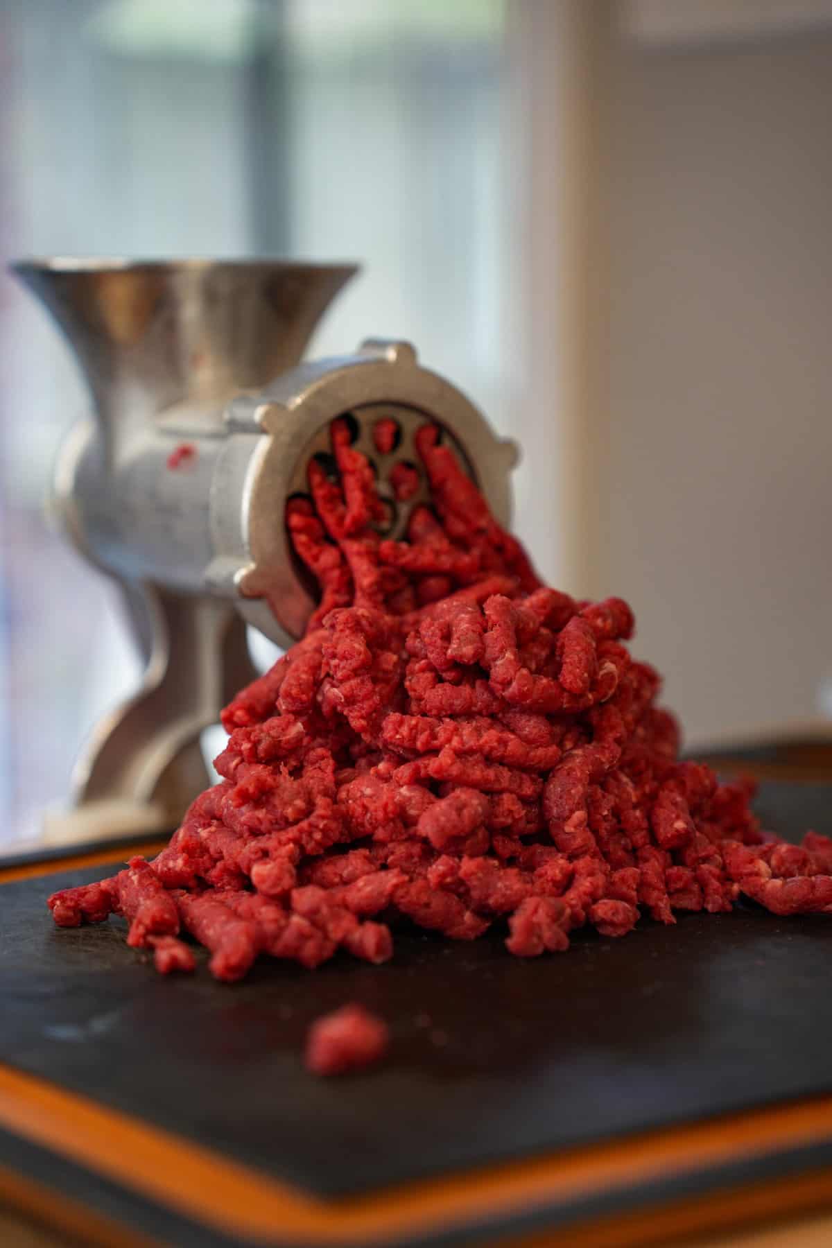 Grinding up the beef so that we can stuff it in the hot dogs.
