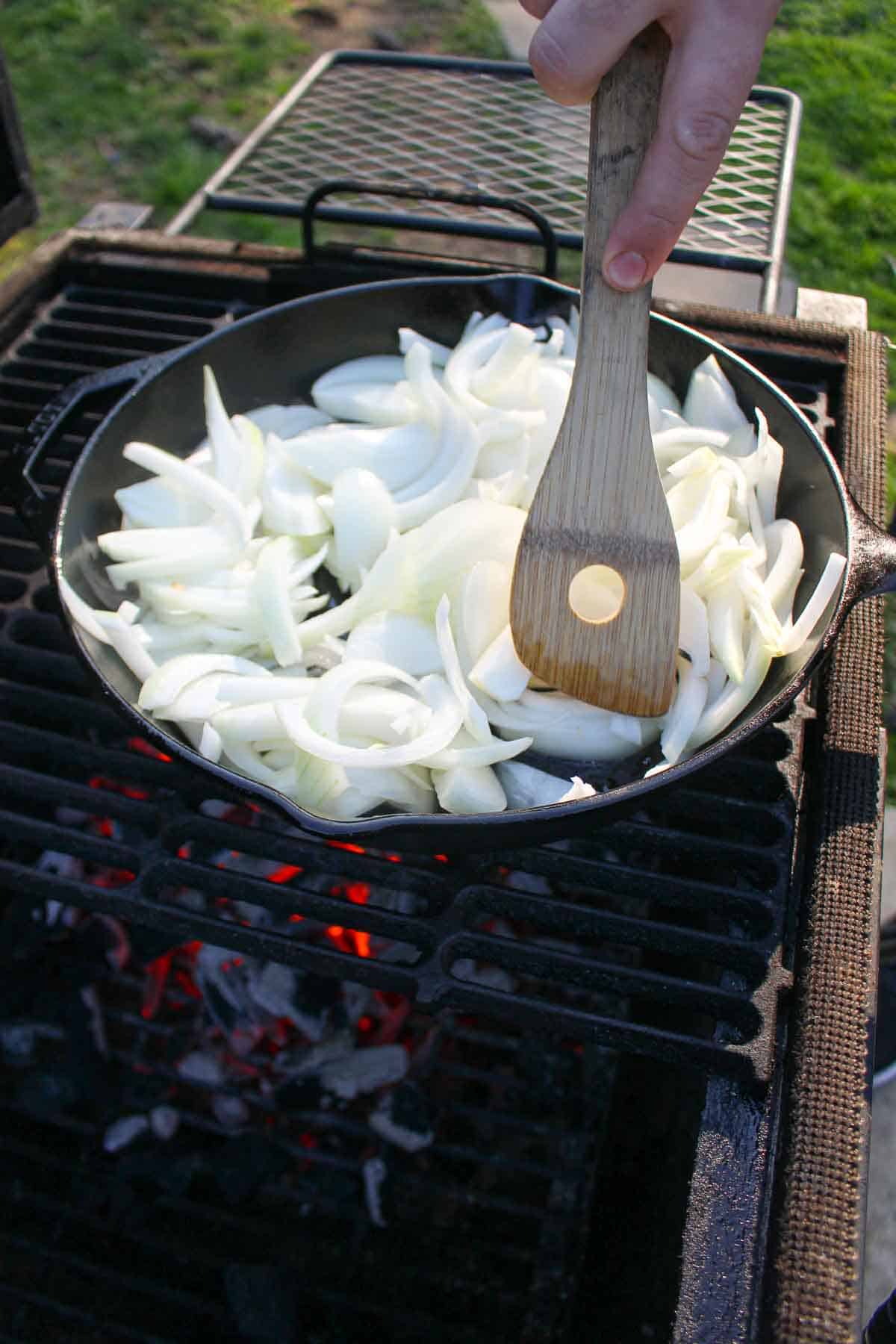 The raw onions starting to sauté over the coals.