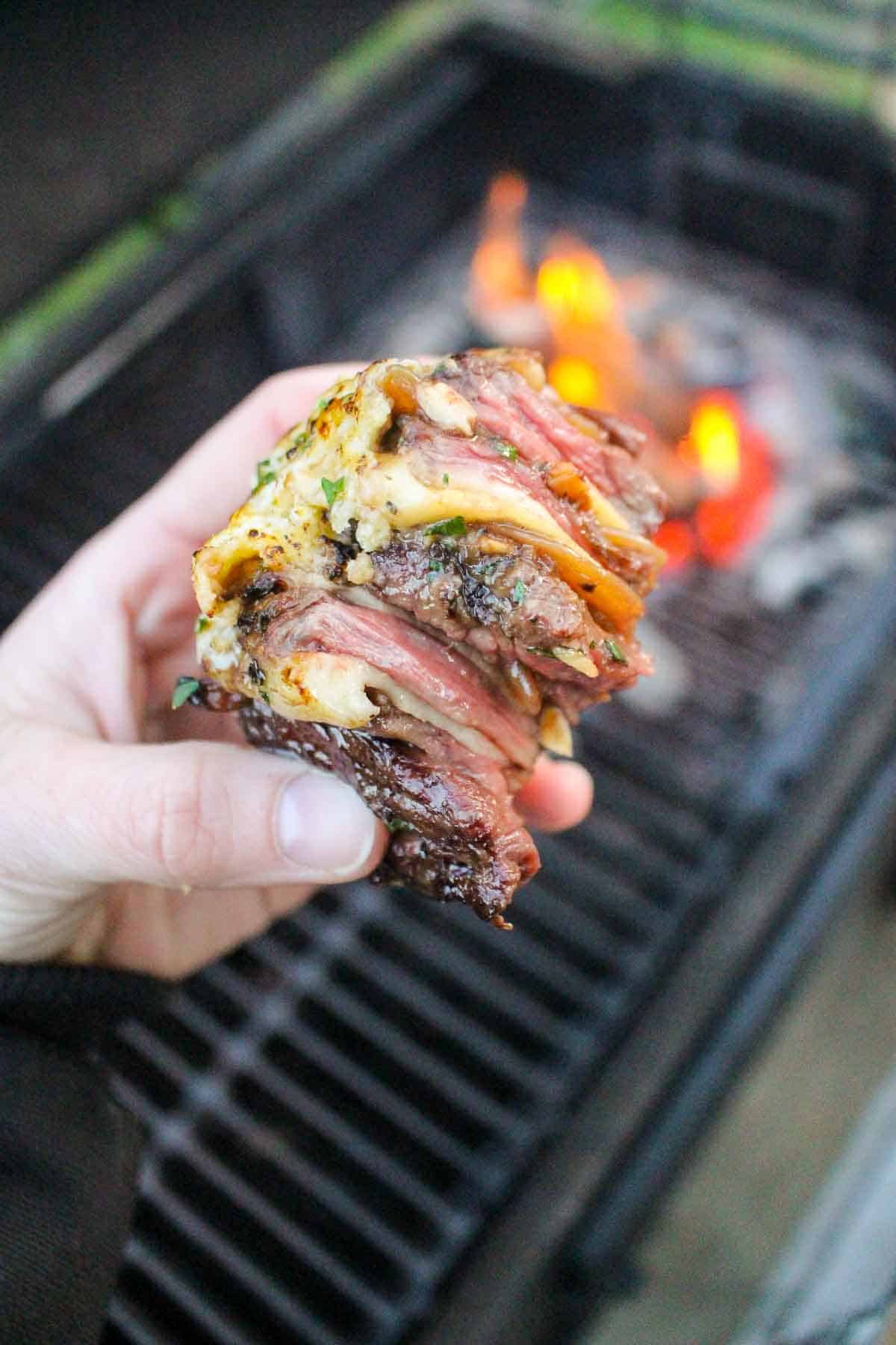 A close up shot of a sliced French onion steak pinwheels so you can see the different layers.