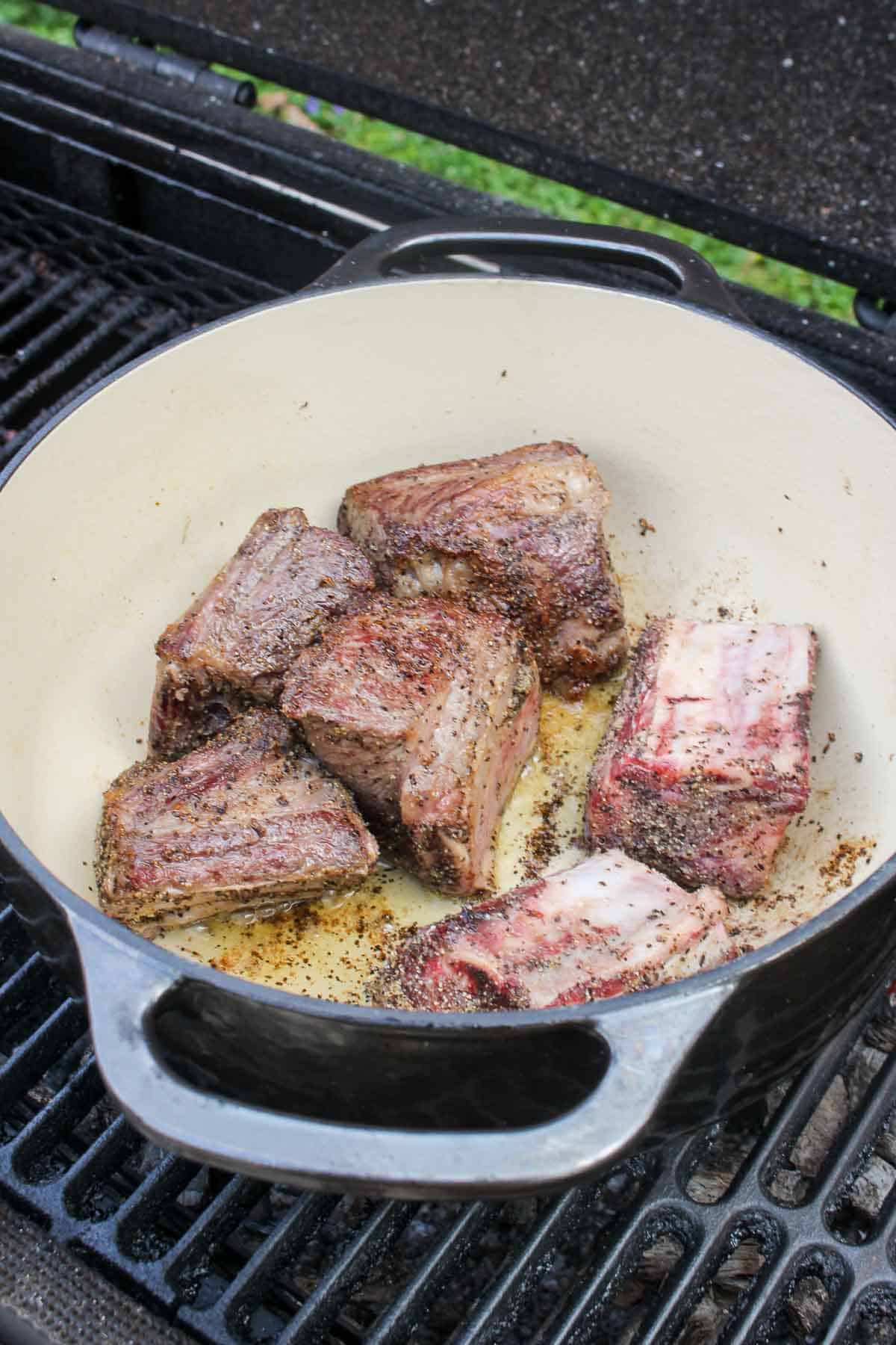 The short ribs after getting seasoned and starting to sear in the dutch oven.