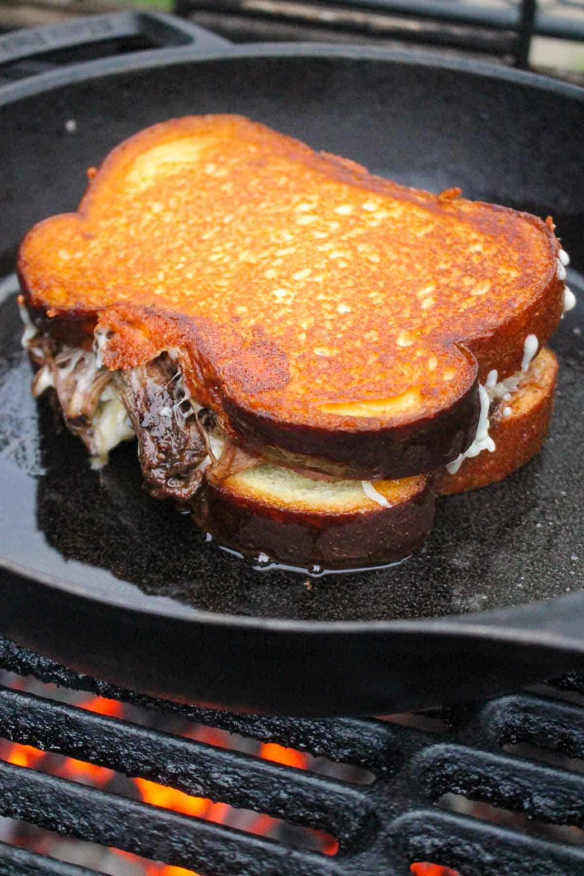One of the sandwiches after being flipped on the grill.
