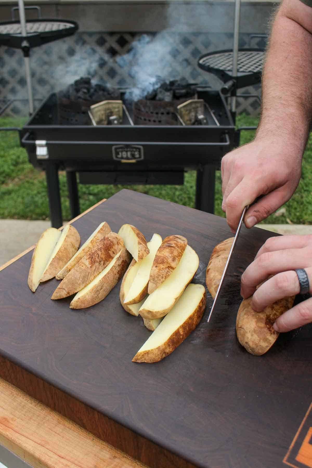 Slicing the potato wedges so we can soak them in ice water. 
