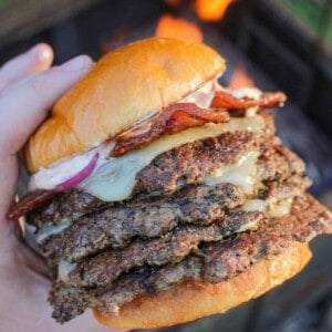 A Jalapeño Popper Smash Burger being held by the fire.