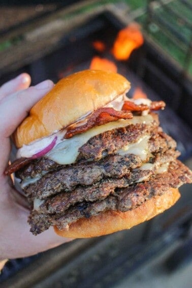 A Jalapeño Popper Smash Burger being held by the fire.