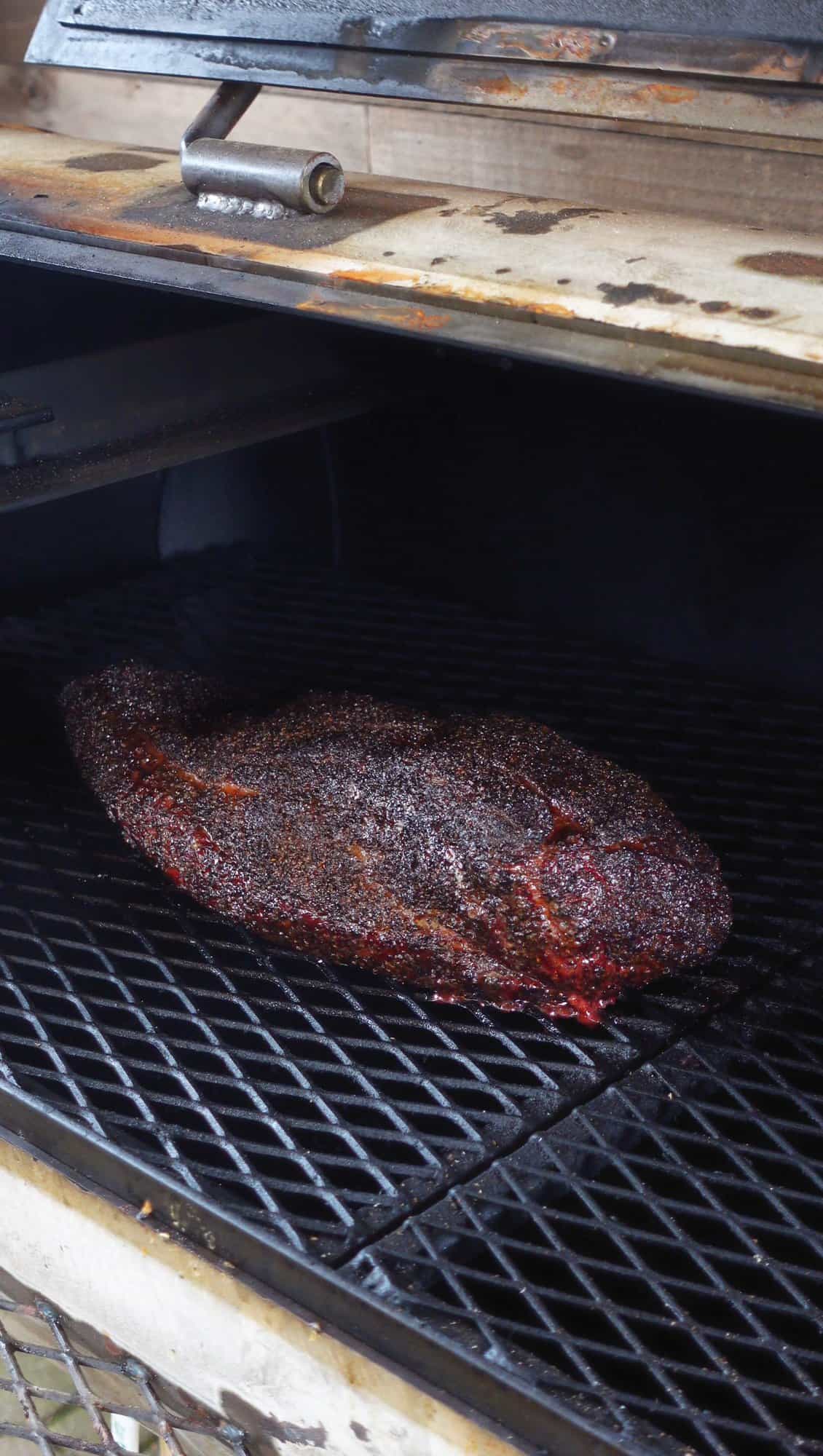 A hot of the brisket cooking on the smoker.