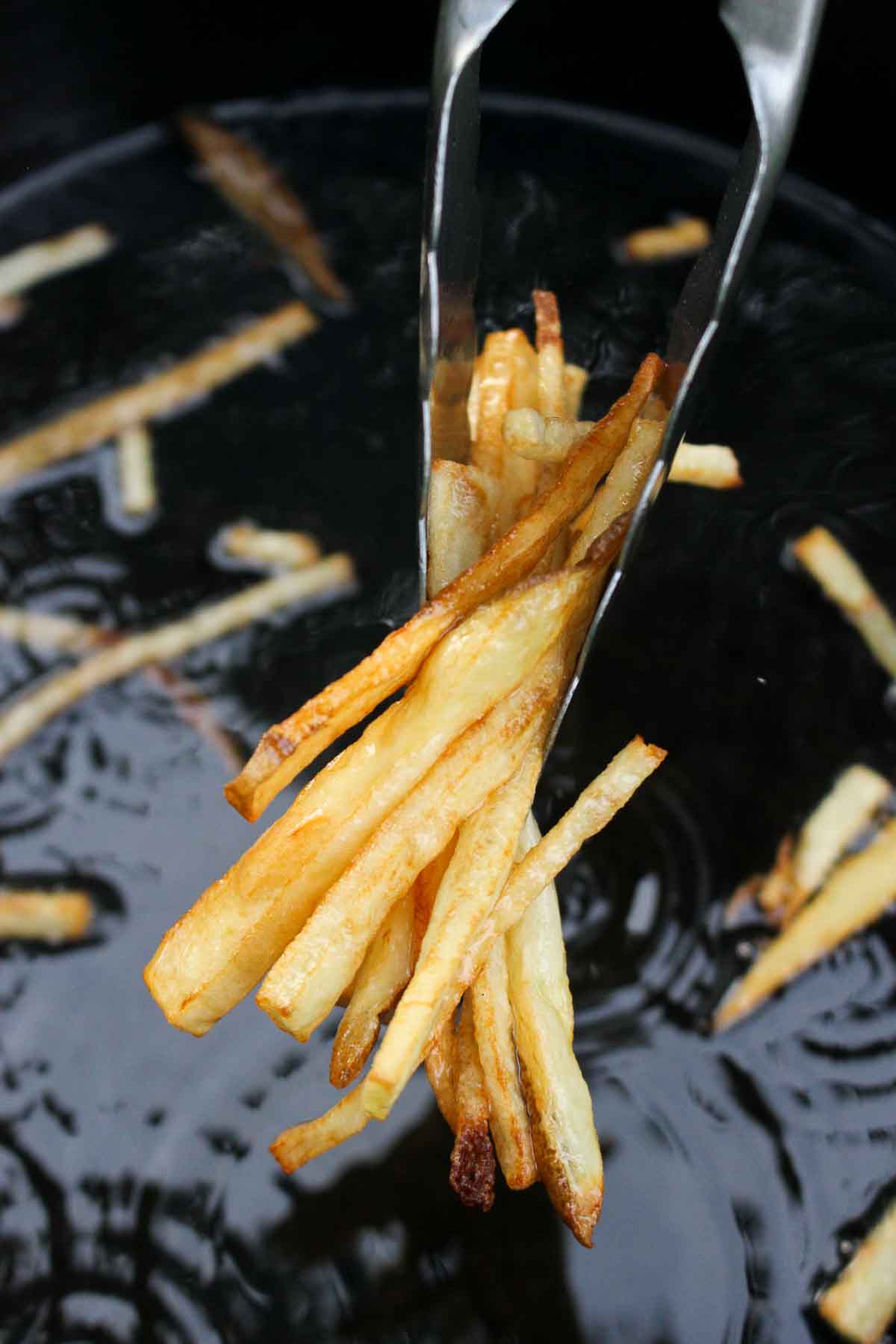Pulling the fries out of the frying oil for our steak frites recipe!