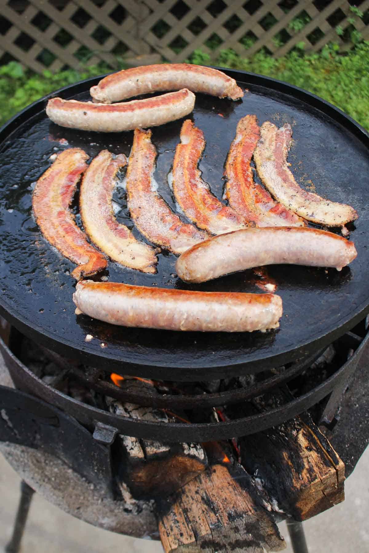 The bacon and sausage for the Ron Swanson Breakfast Skillet on the grill. 