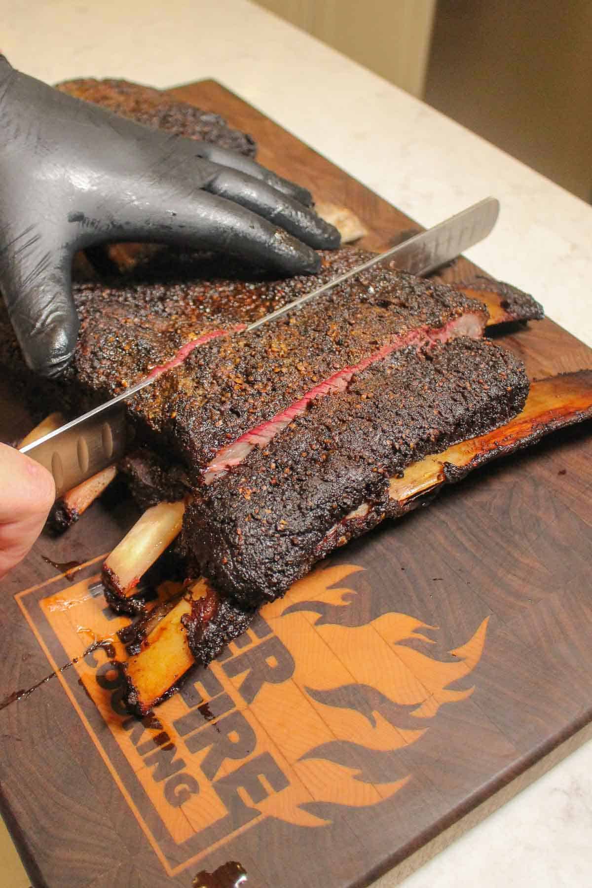 Slicing into the rack of ribs.