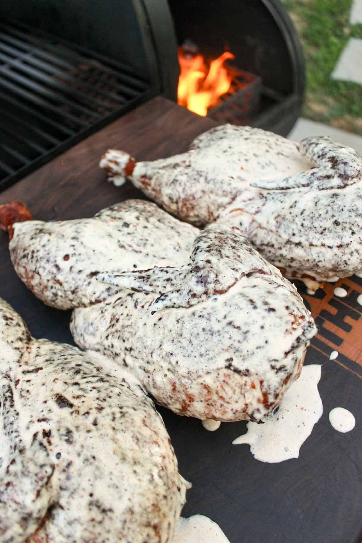 A close up shot of the smoked chicken with Alabama white sauce. 