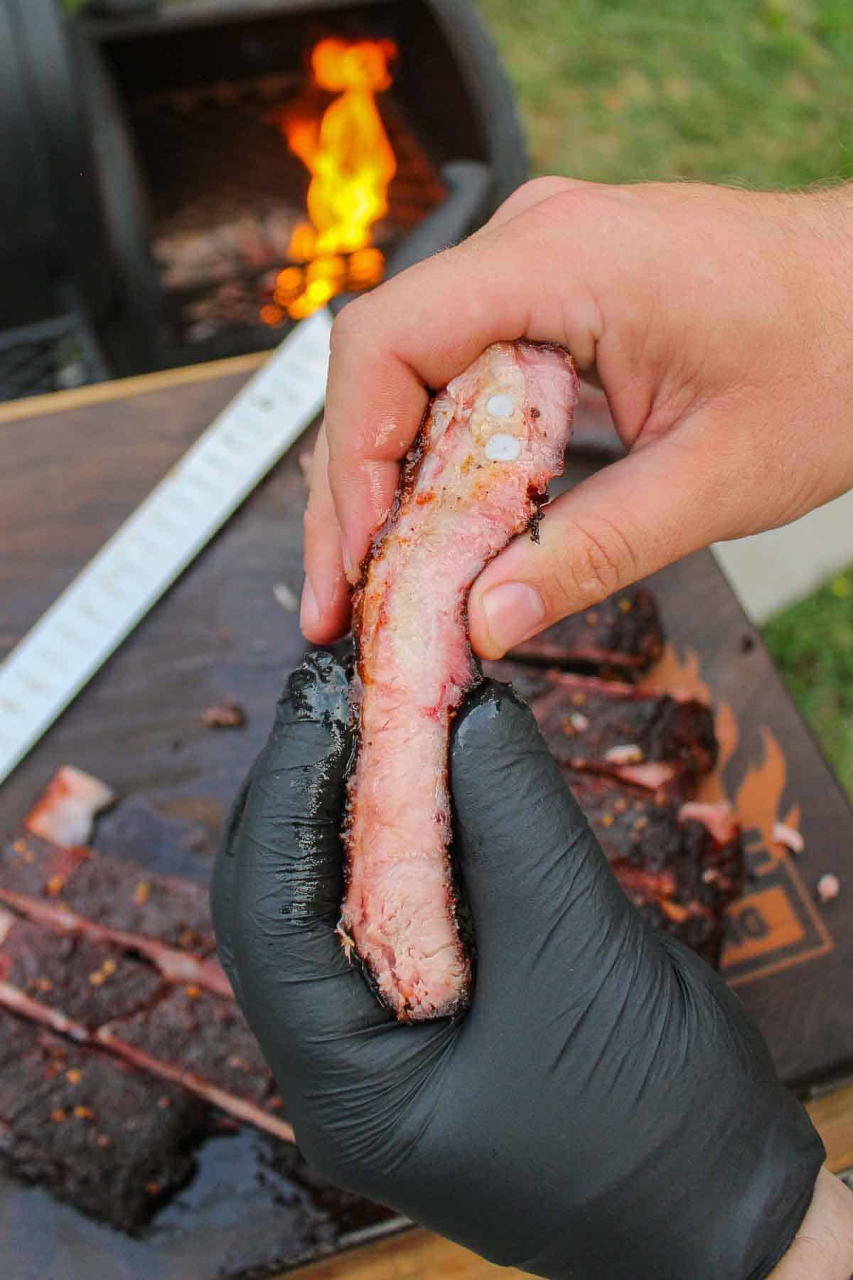A close up shot of a sliced smoked rib.