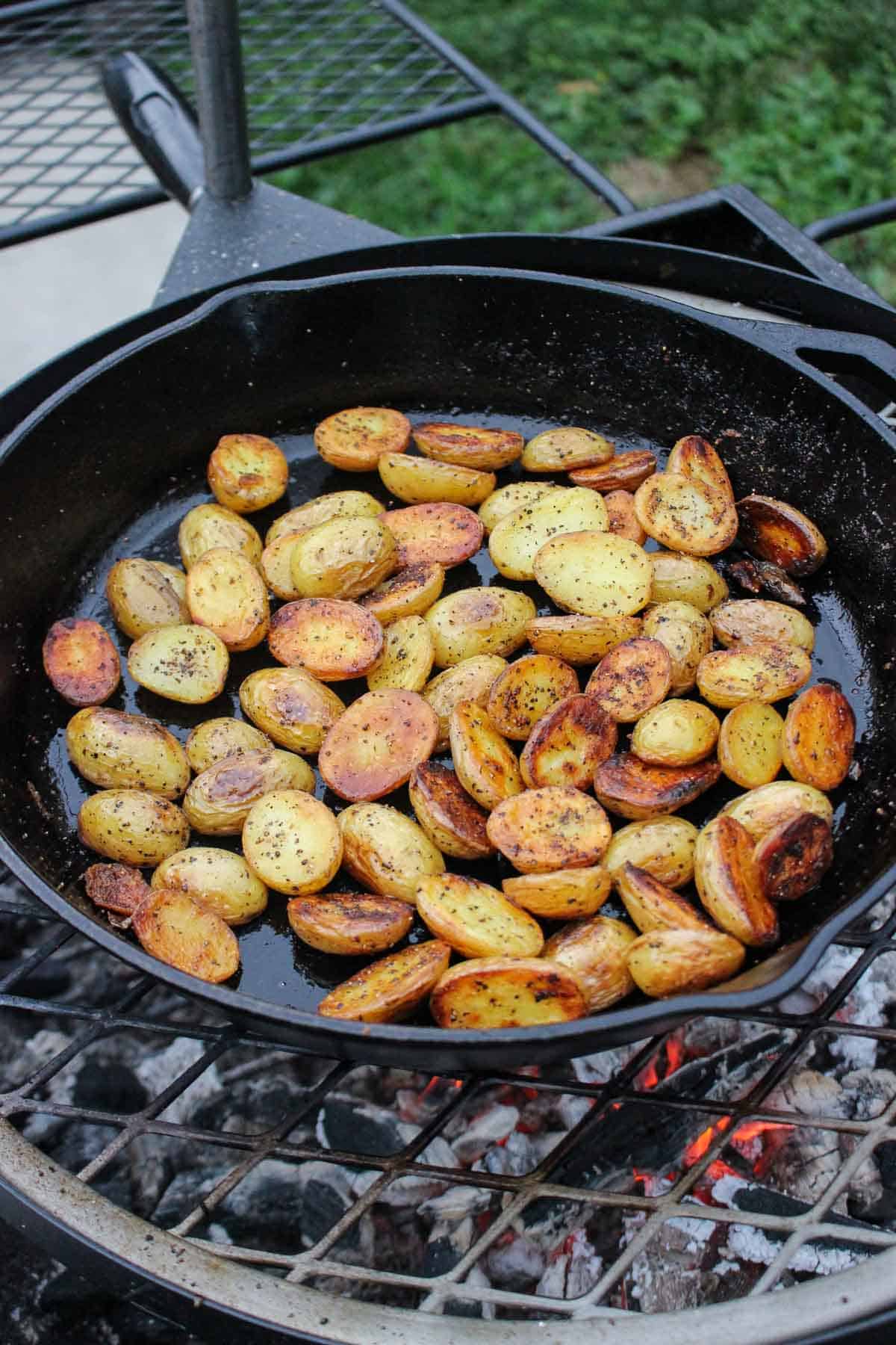 The roasted potatoes that are golden brown and ready to be served along side the steak onion skewers. 