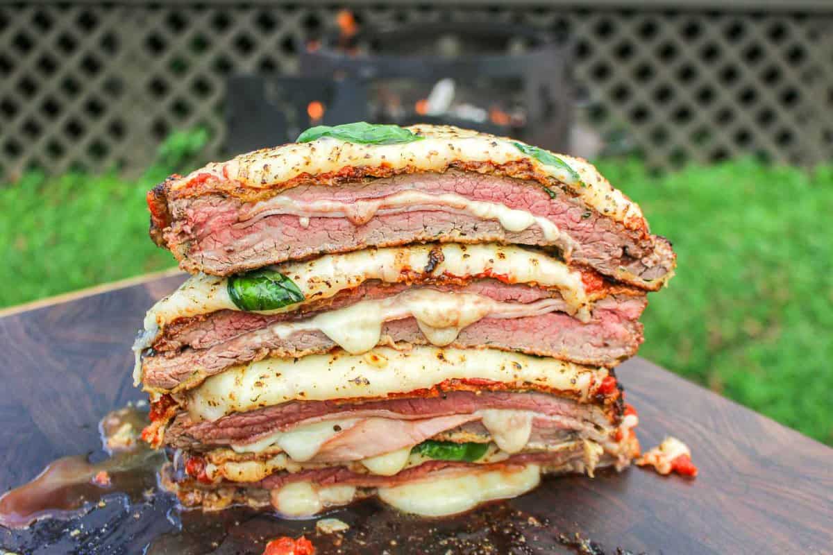 The sliced and stacked Milanesa Napolitana on a cutting board.