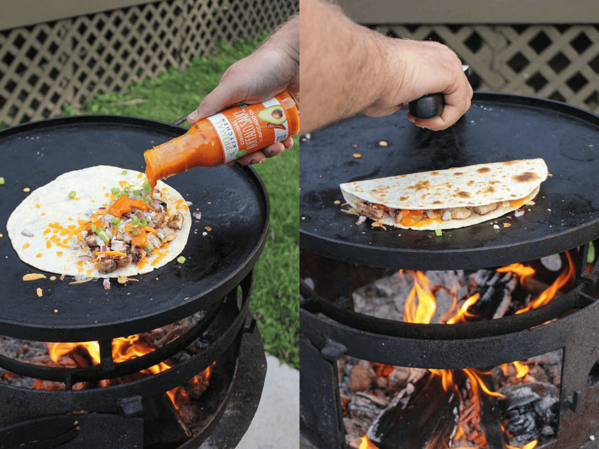 Adding all the ingredients to the open flour tortilla on the grill.