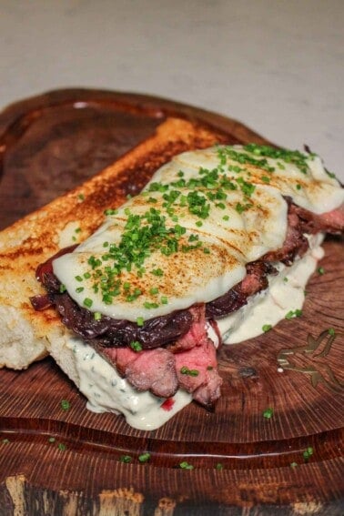 The Peter Luger Steak Sandwich assembled and ready to slice before serving.