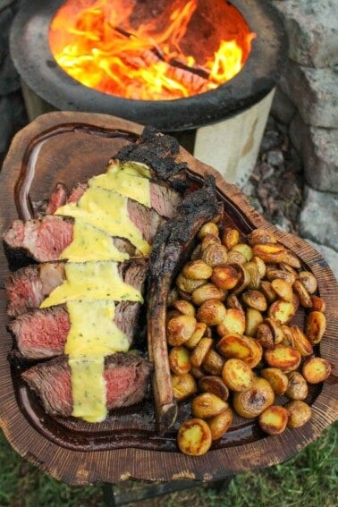 Steak with Béarnaise Sauce sliced and served with roasted potatoes.