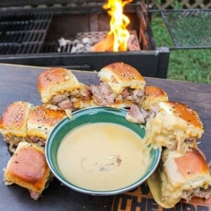 Steak Sliders with Beer Cheese plated next to the beer cheese ready to serve.