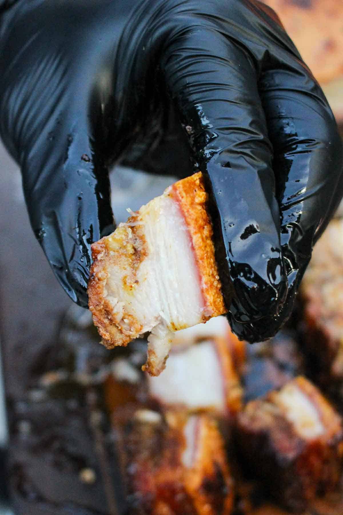 A close up shot of a single crispy pork belly burnt end.