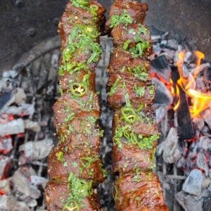 Black Pepper Steak Skewers finishing up their cooking process over the fire.