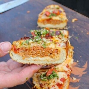 A sliced shot of the pizza bread being held up to the camera.