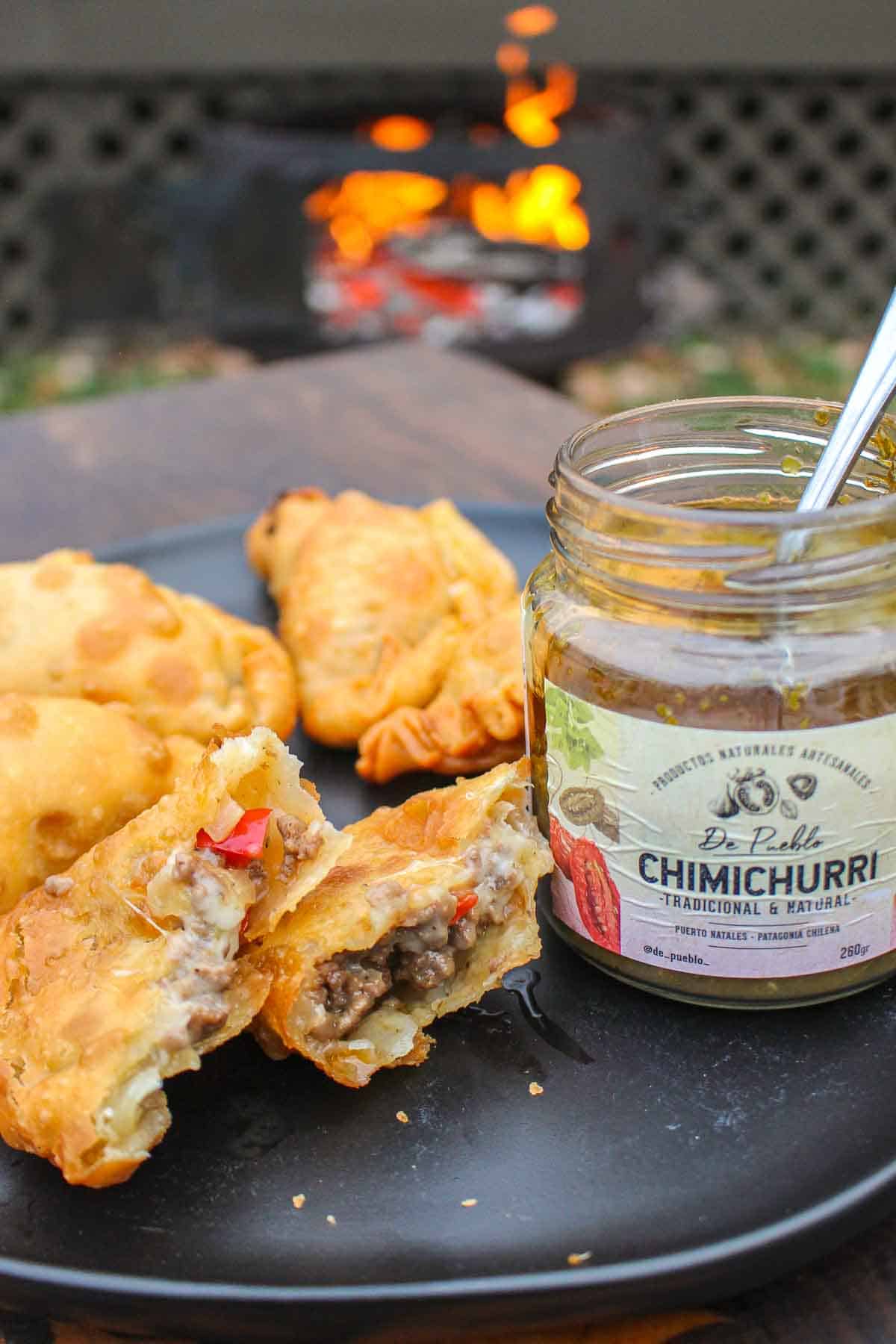 The empanadas are served with traditional chimichurri sauce. 