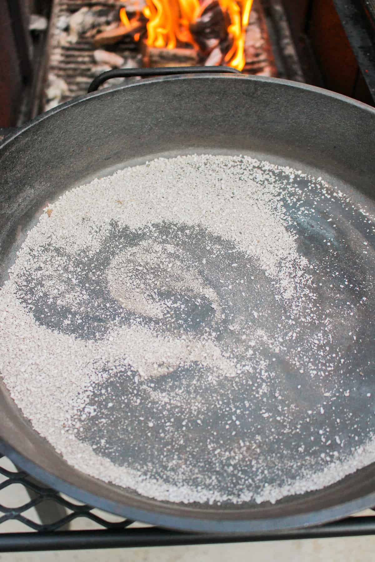 A pan after rubbing it down with salt, ready to be washed with warm water.