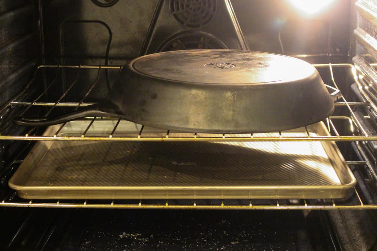 A cast iron pan cooling slowly in the oven.