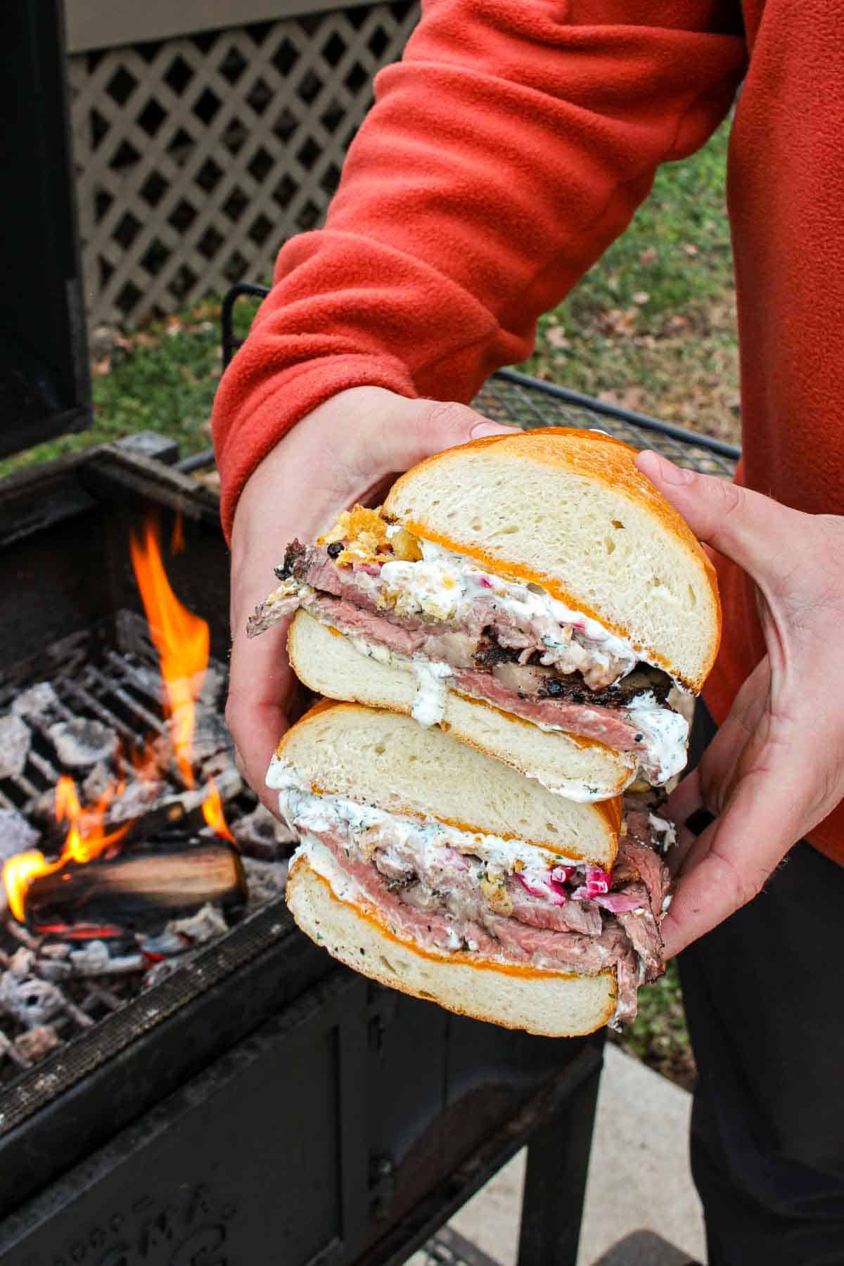 The steak sandwich cut in half, oozing with juicy flavor and textures. 