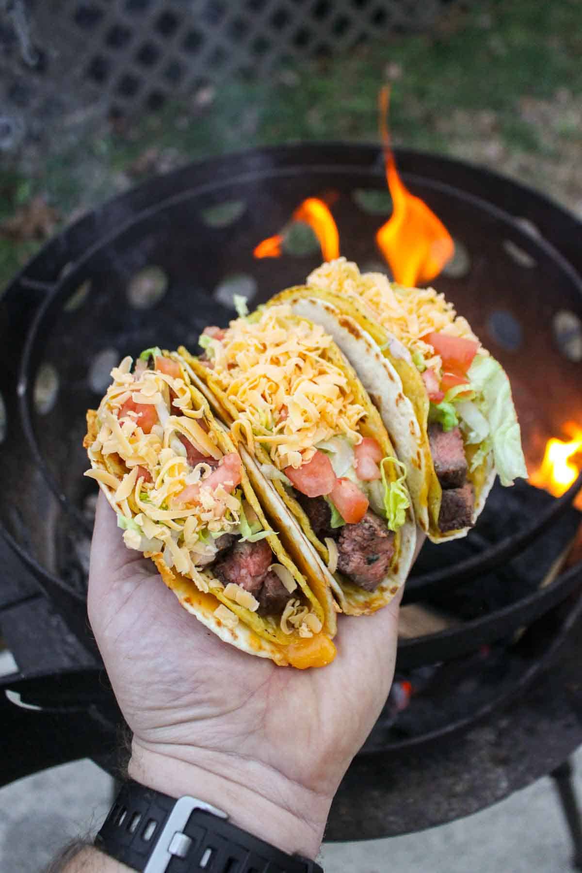 A photo of the Cheesy Gordita Crunch Tacos over the fire. 