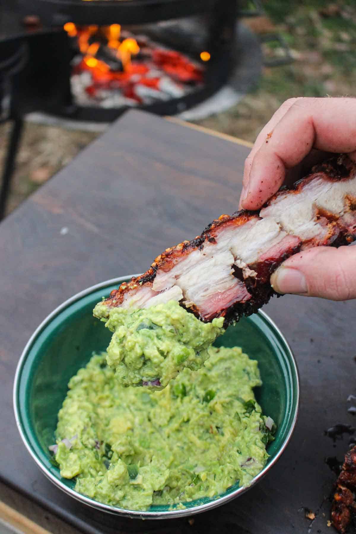 Each slice of fried pork belly is dipped into the fresh homemade guacamole. 