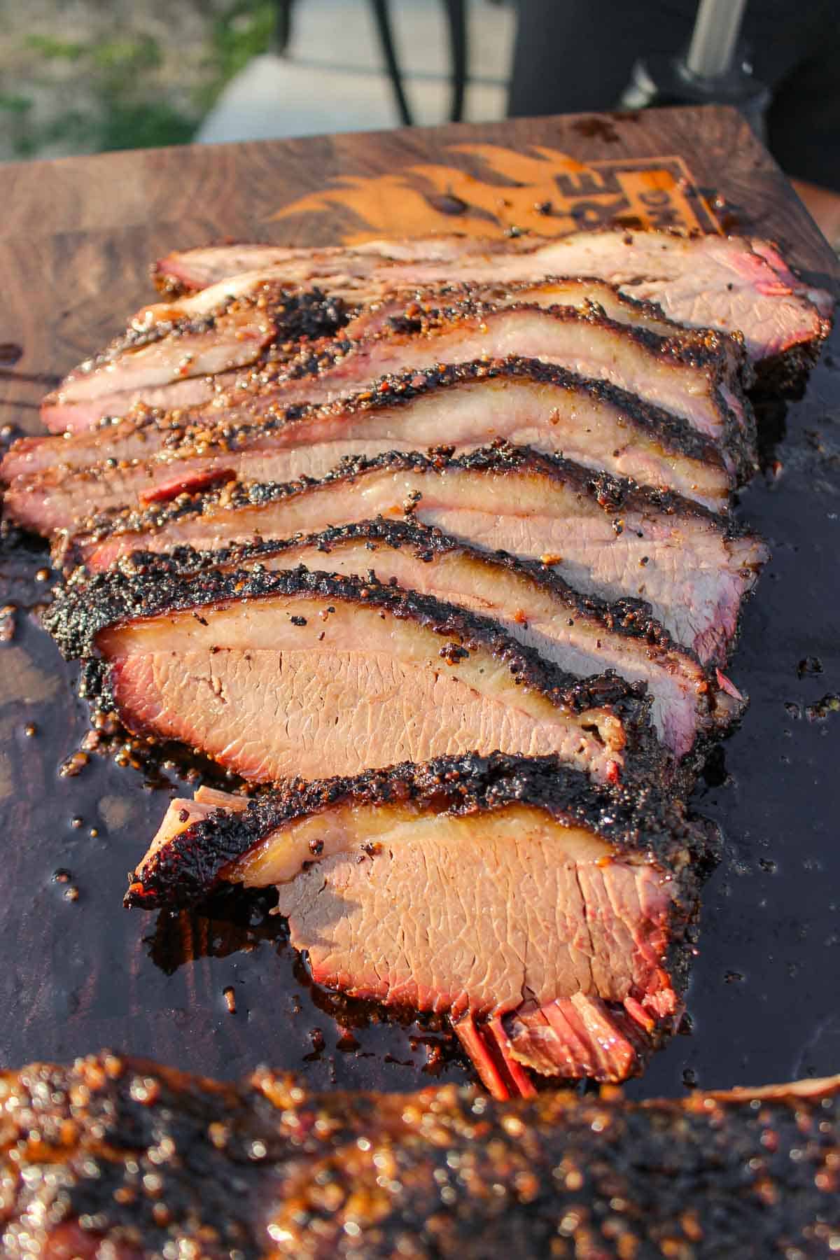 Overnight smoked brisket that melts in your mouth is sliced and served. 