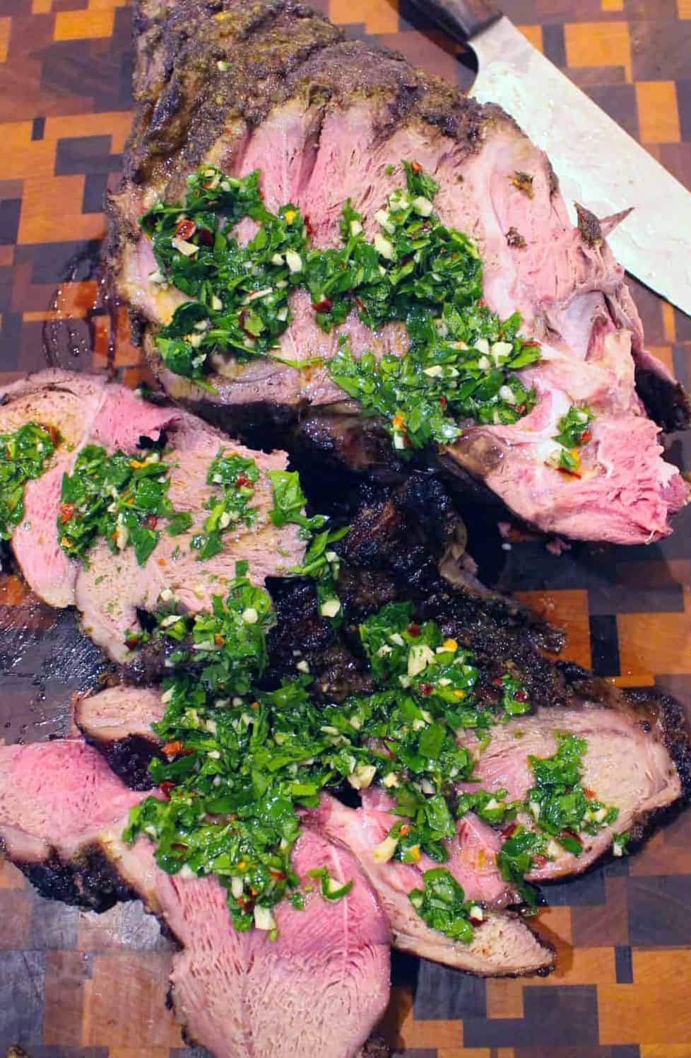 The leg of lamb is sliced and served with the zesty chimichurri sauce. 
