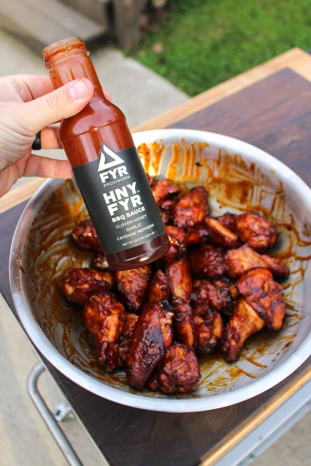 The bbq sauce covers the smoked and fried chicken wings. 
