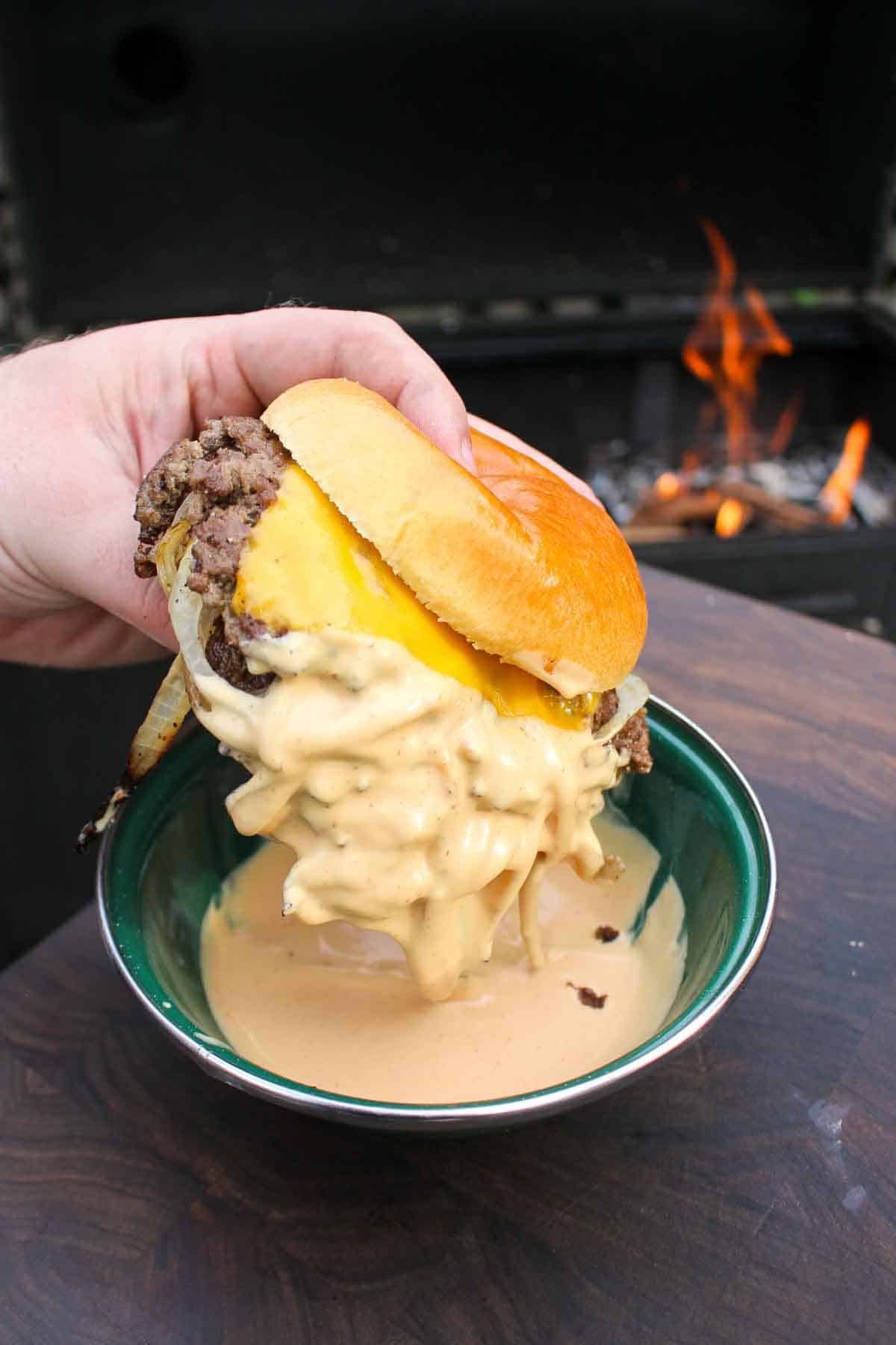 The onion burger is dipped in special sauce. 