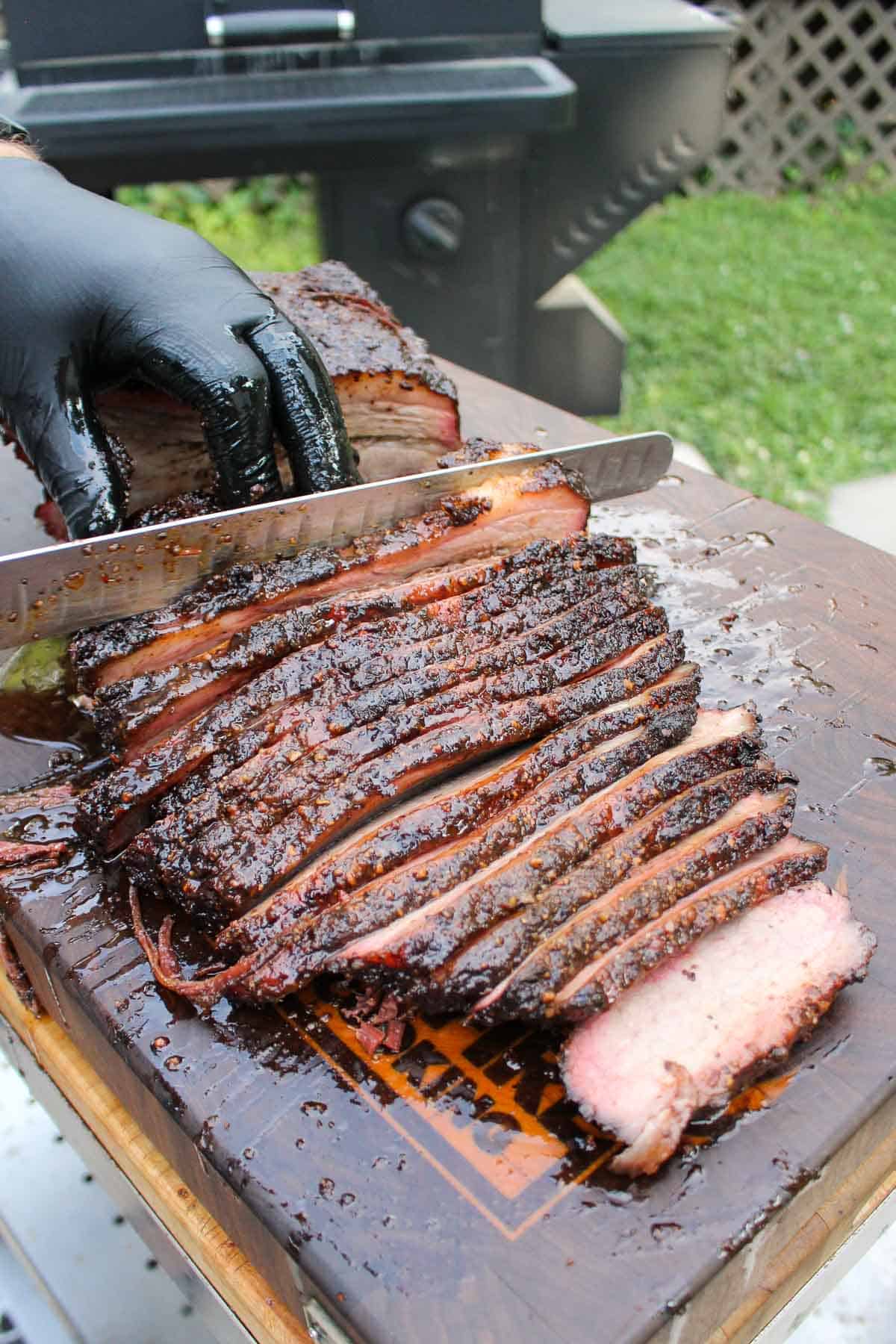 Slicing brisket into pencil thick slices.