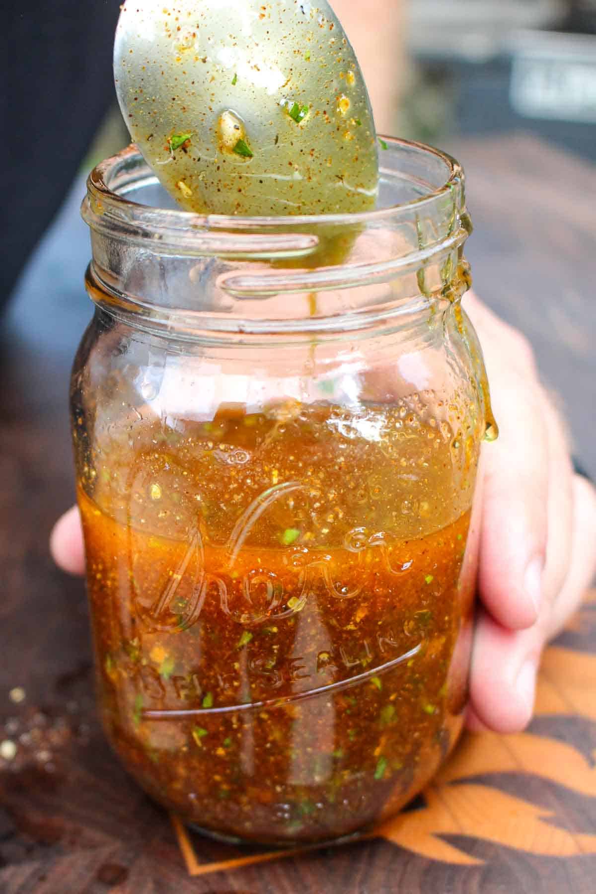 Mixing the hot honey butter in the mason jar.