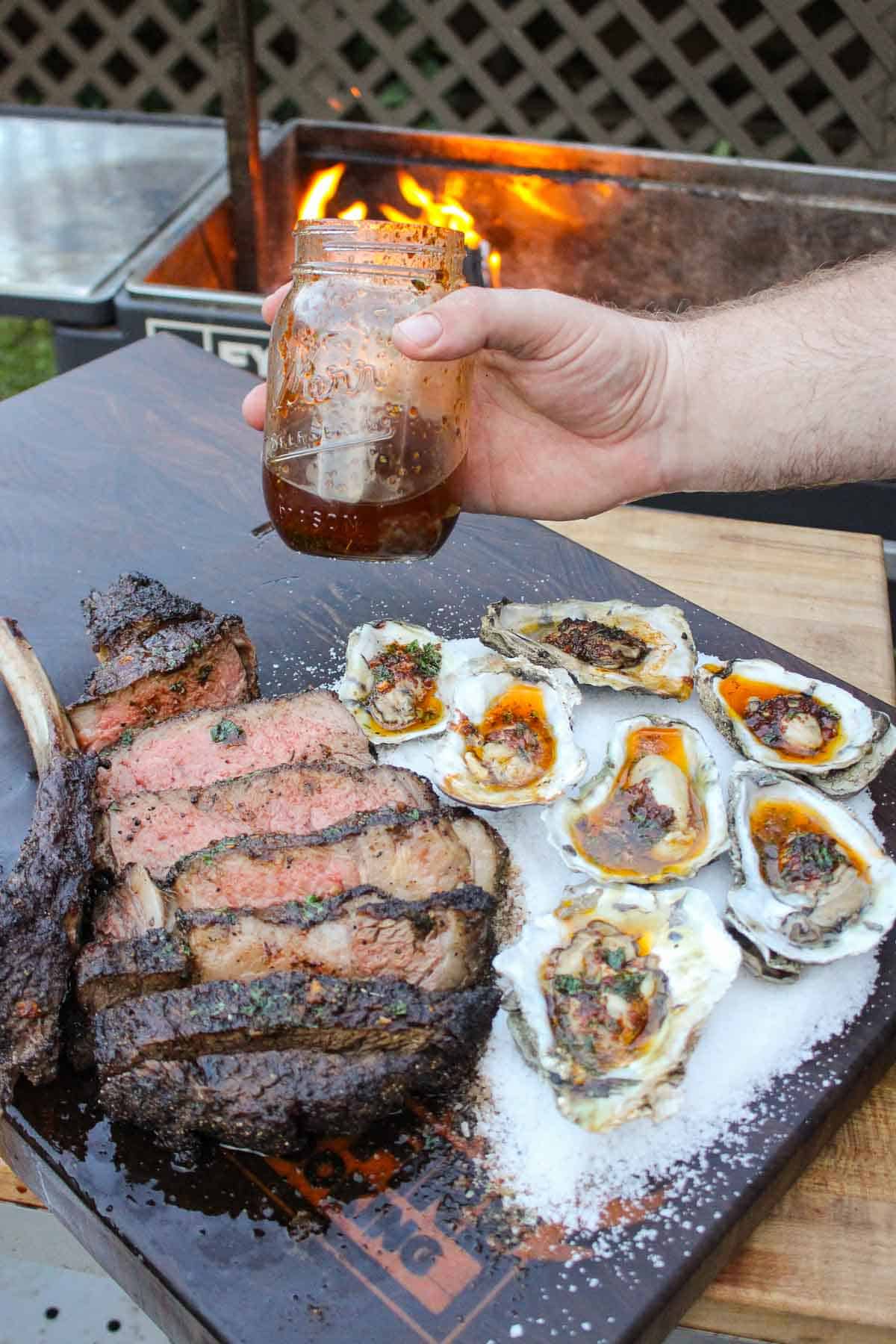 Steak and oysters topped with butter.