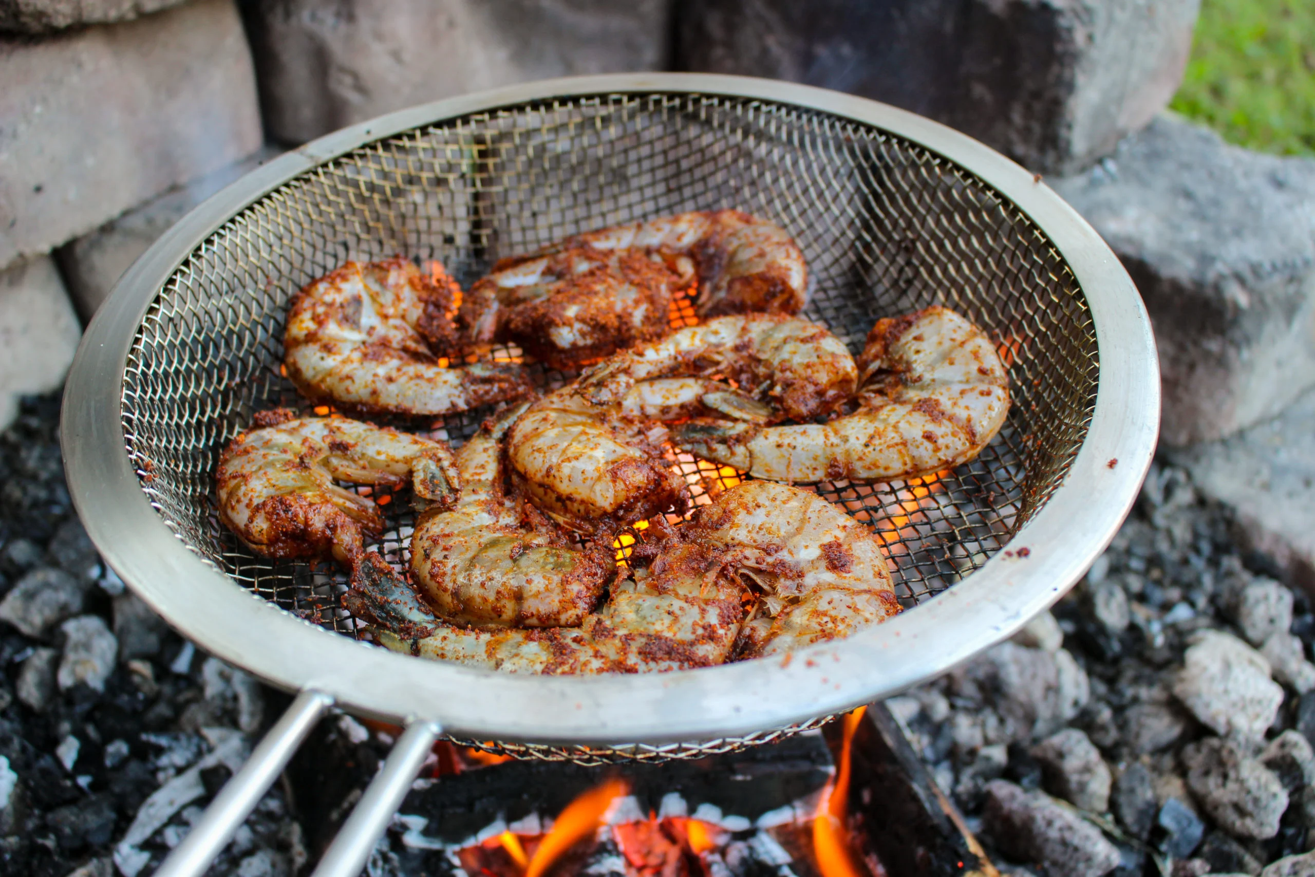 Shrimp cooking in a grill basket. 