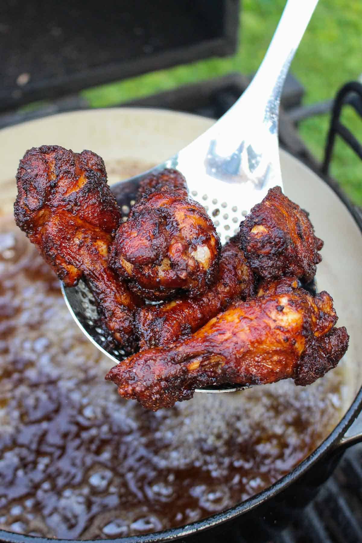 Chicken coming out of the frying oil.