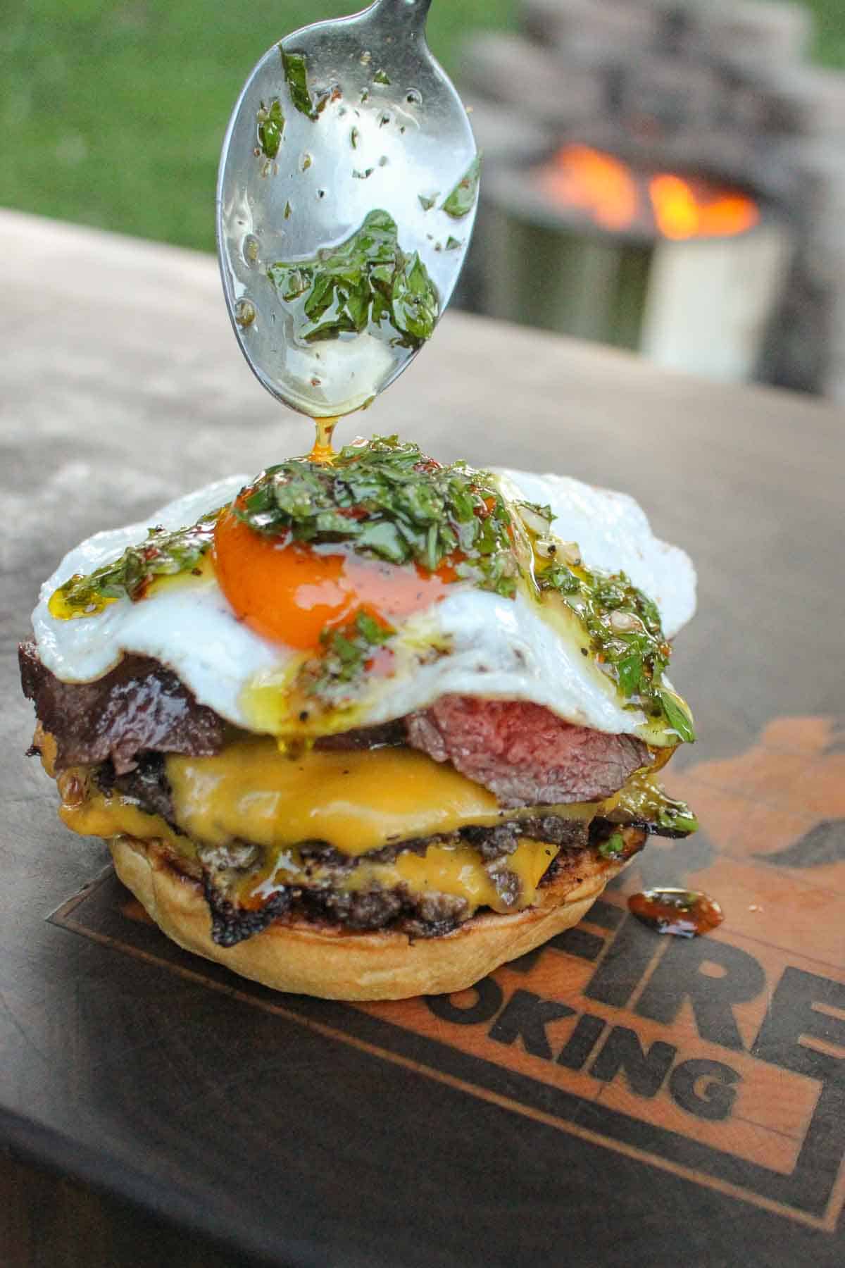 The chimichurri sauce is drizzled over the fried egg. 