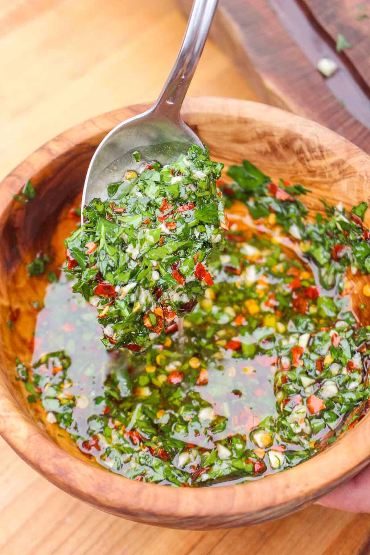 The classic chimichurri sauce mixed together in a serving bowl. 