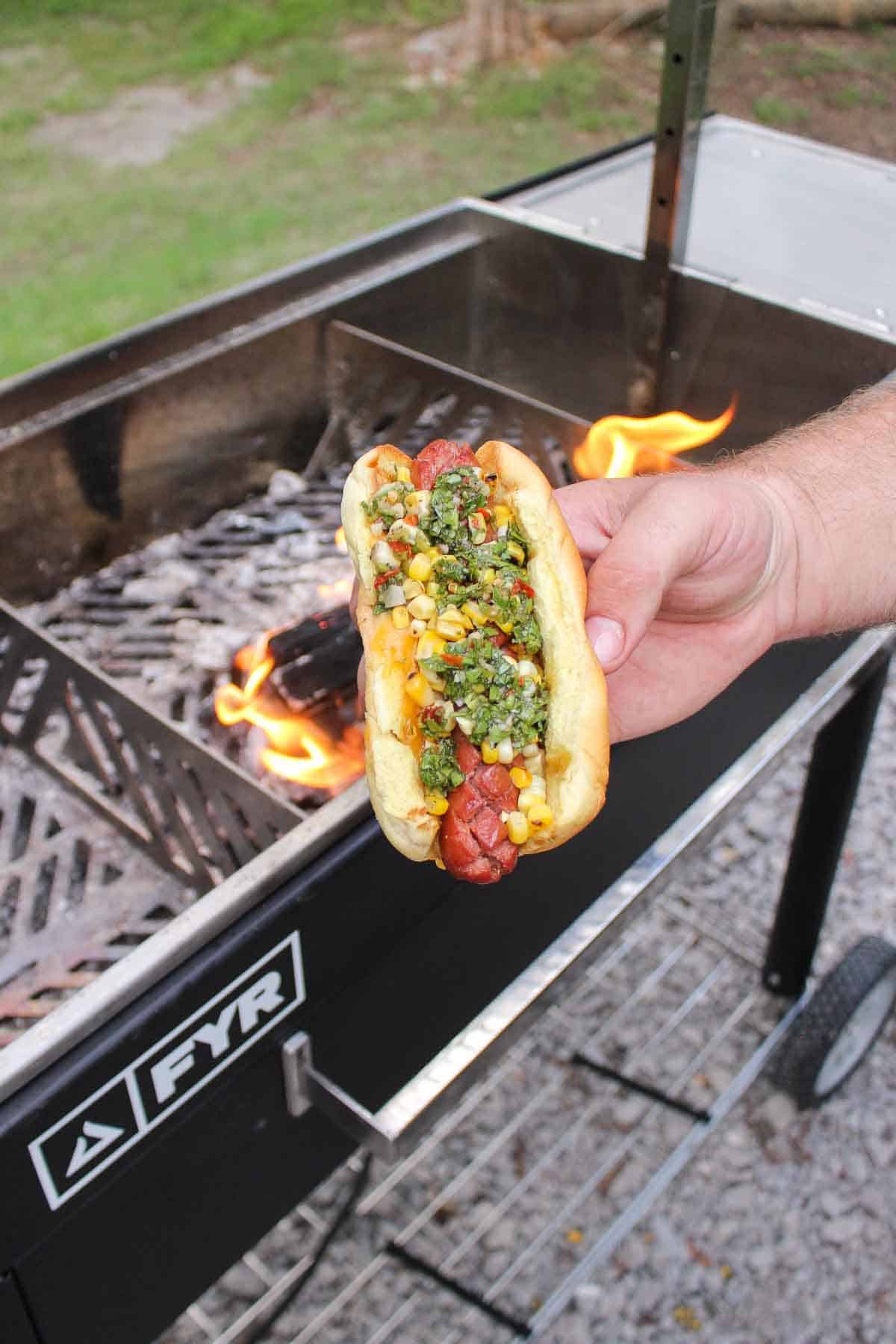 Grilled hot dog in front of the FYR Grill.