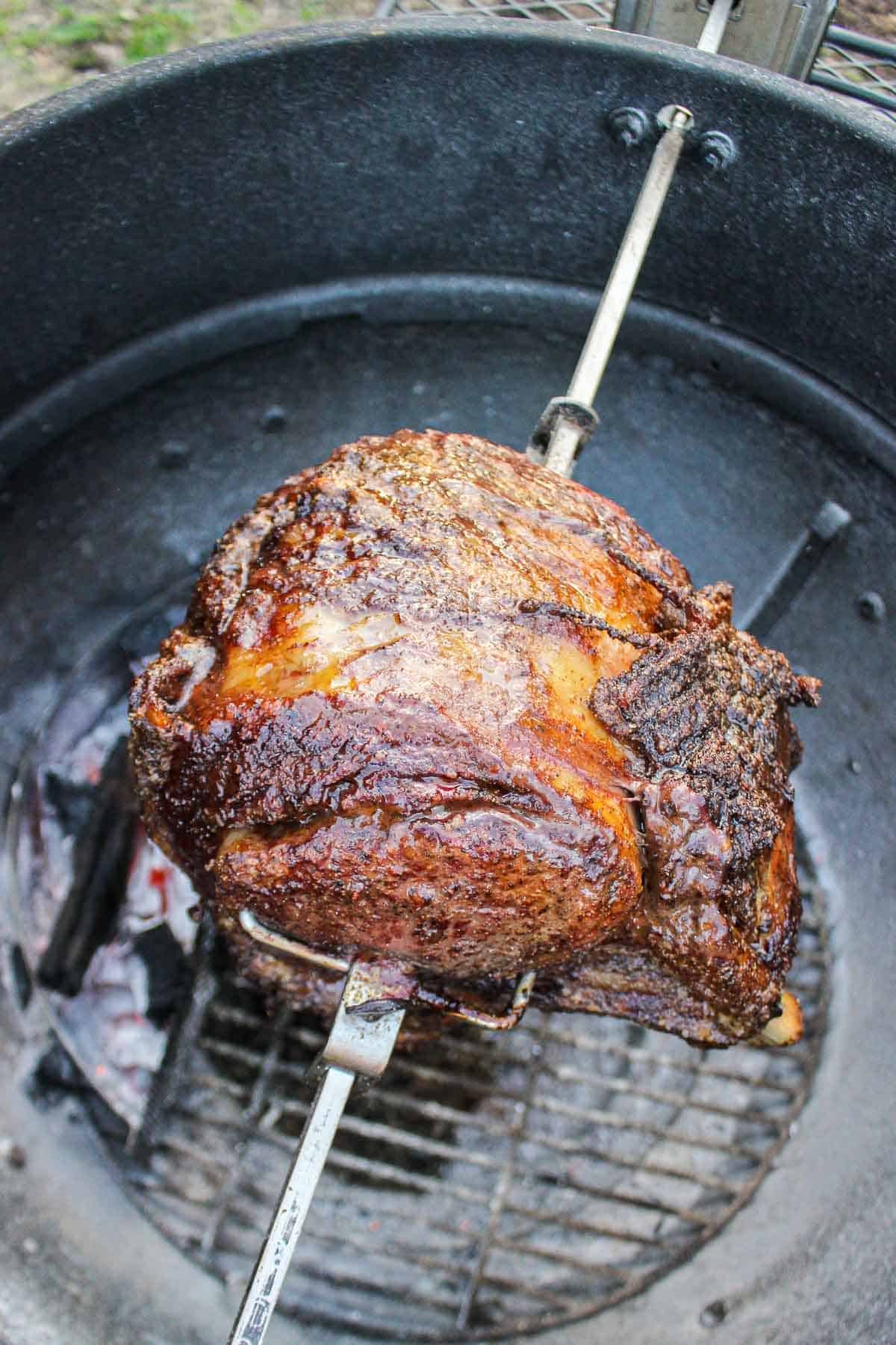 A NY Strip roast cooking over the coals.