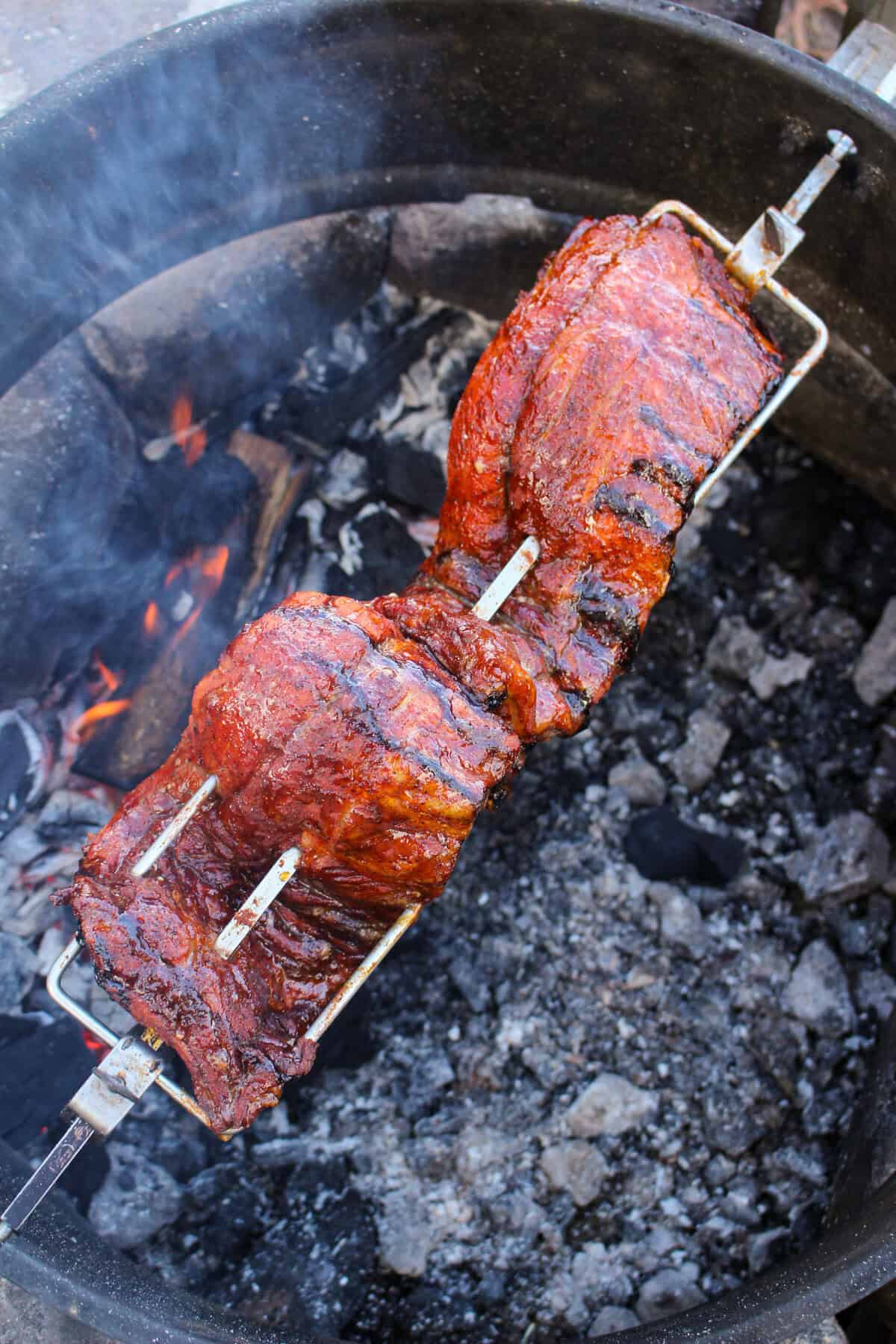 Ribs rotating on a spit over the fire. 