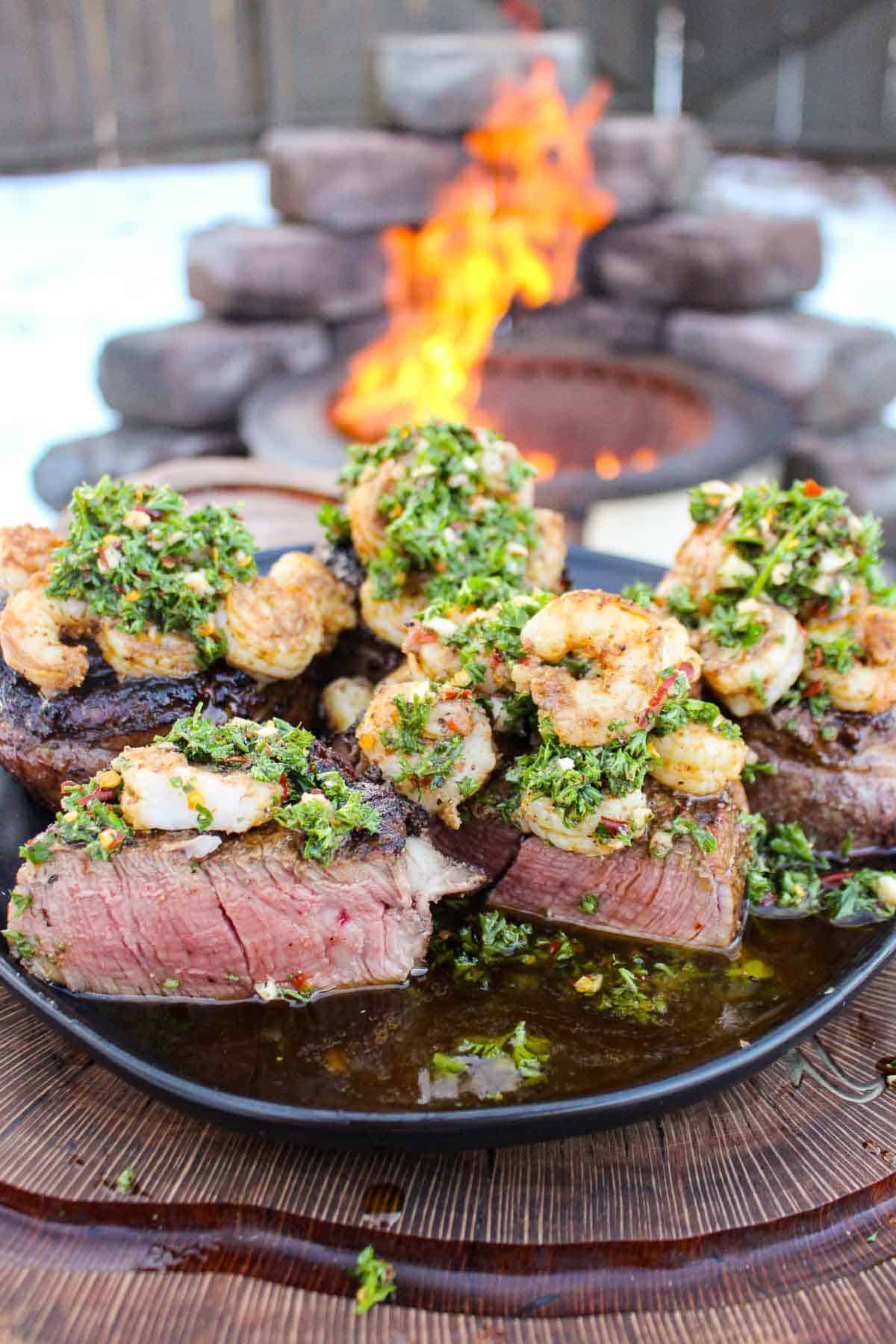 Steak and shrimp grilled over the fire. 