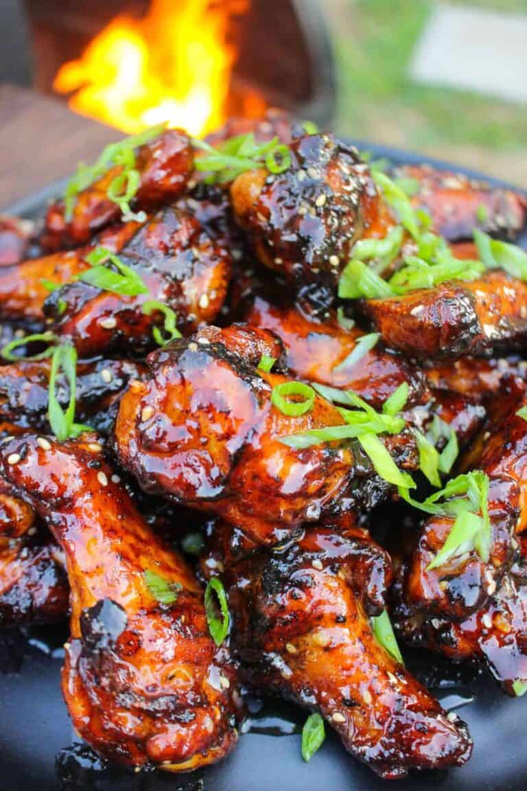 A plate full of sticky wings, garnished and ready to devour!