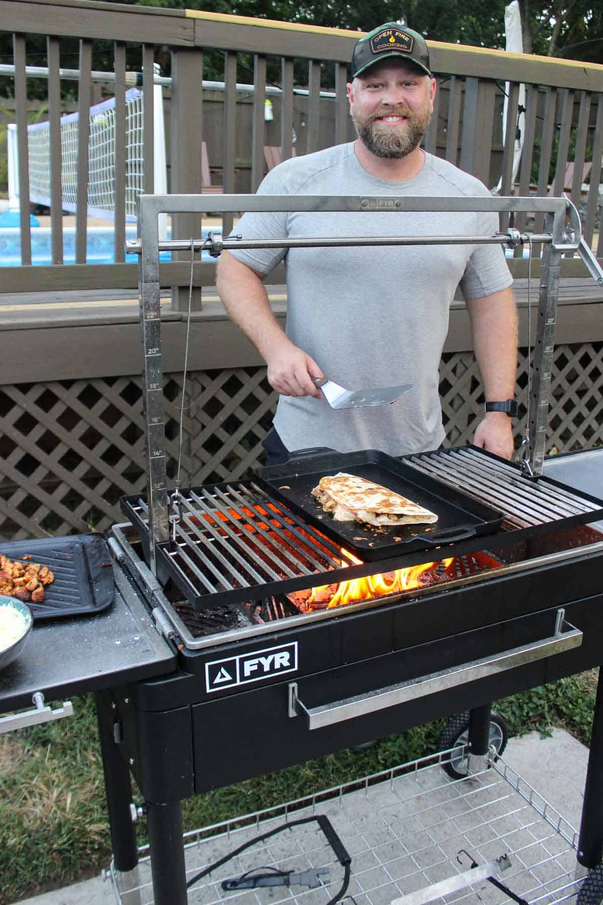 Derek Wolf in front of his new FYR Grill and a crispy chicken quesadilla. 